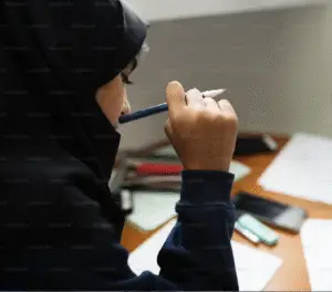Student contemplating with a pencil. | Donate Today | Secure Her Future Online |